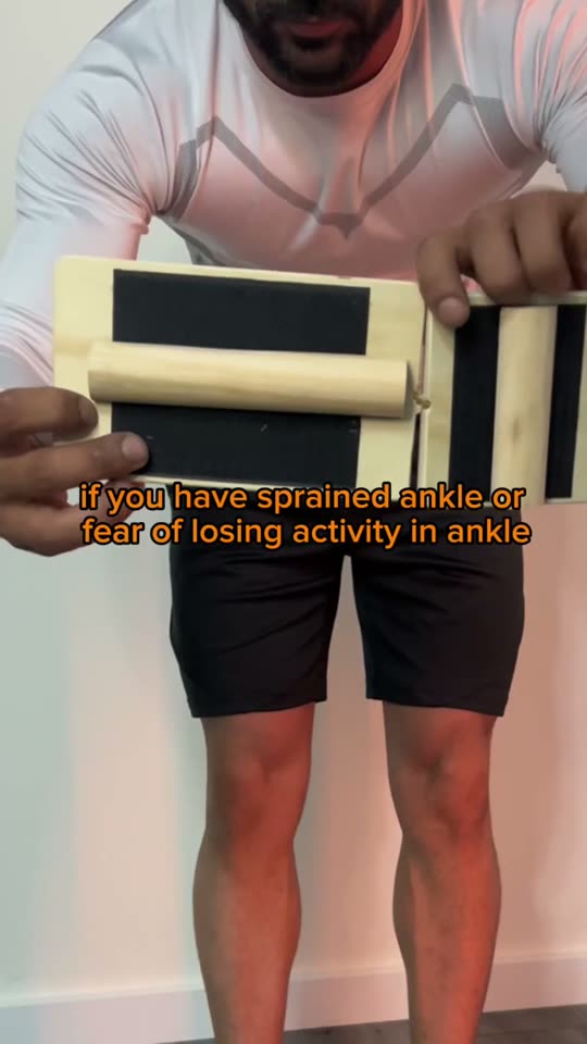 Hands holding a wooden ankle-strengthening board