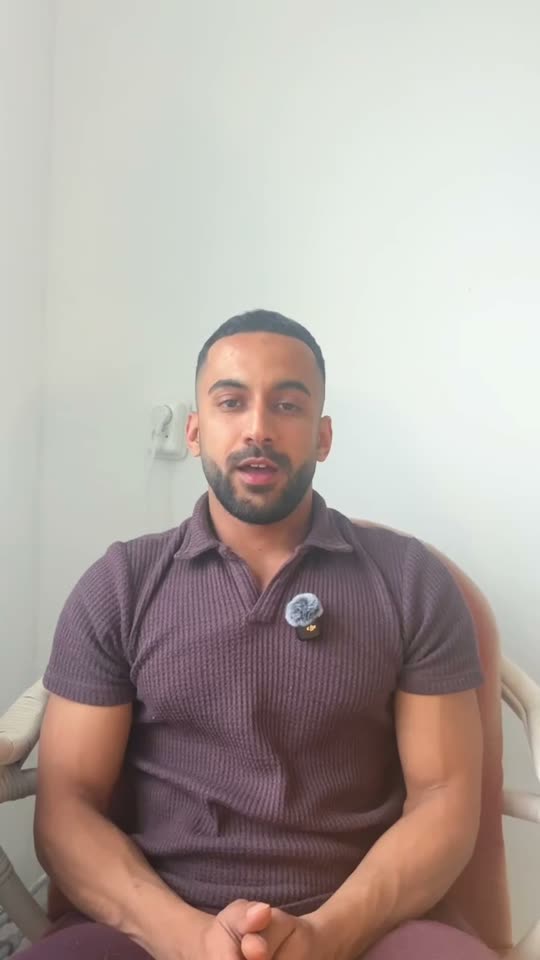 Moo seated in a polo shirt speaking to camera