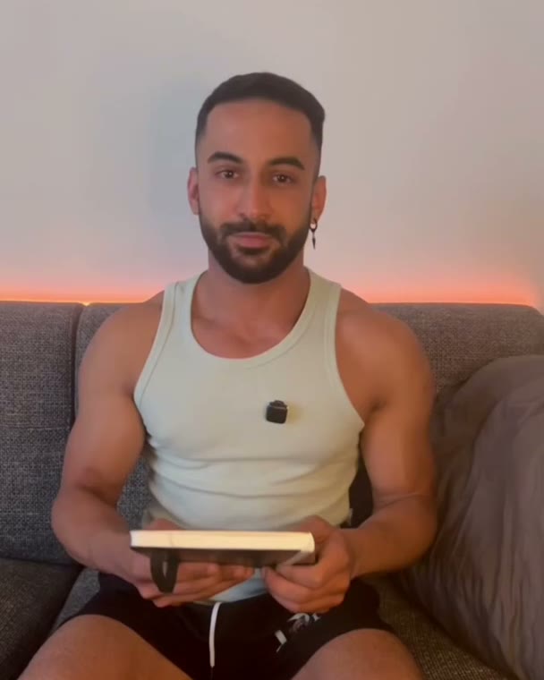 Moo on a sofa with a product, warm light