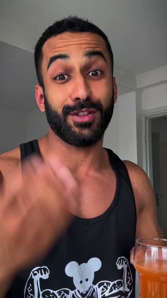 Moo in a gym tank top talking to camera