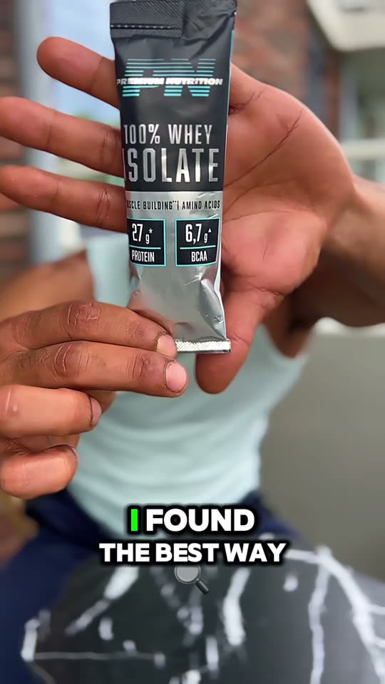 Hand holding a whey isolate protein sachet